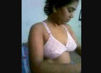 Busty indian girl Poorna in pink bra changing in her bedroom