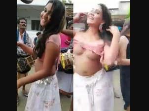 two whore nude dance in village, public place, infront of people